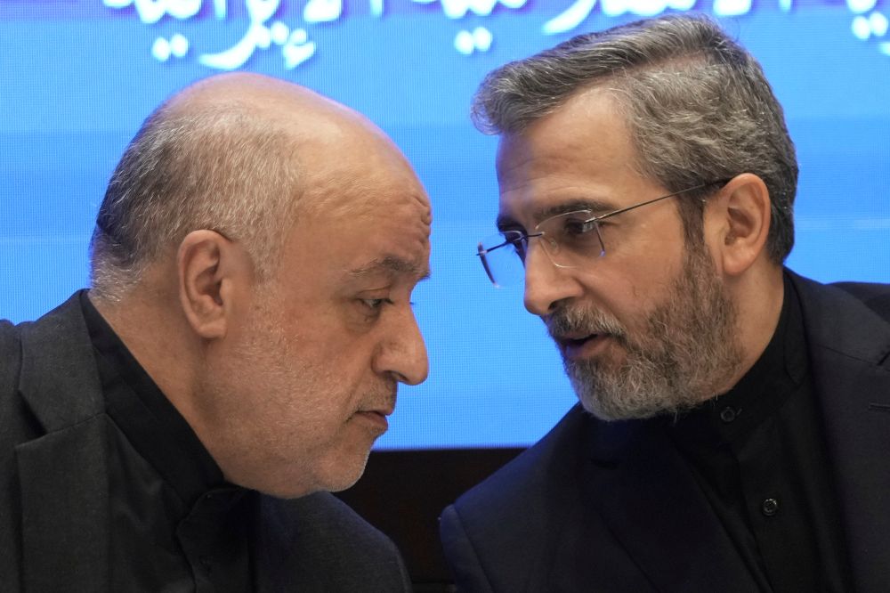 Iranian interim Foreign Minister Ali Bagheri Kani, right, speaks with Iranian Ambassador to Lebanon, Mojtaba Amani, during a press conference at the Iranian Embassy in Beirut, Lebanon