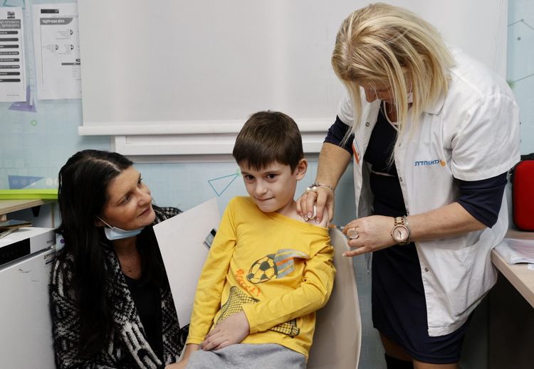 Israeli boy Yoav, 9, receives a dose of the Pfizer/BioNTech Covid vaccine at the Meuhedet Healthcare Services Organisation in Tel Aviv, Israel on November 22, 2021.