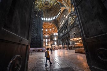A man walks through one of the huge doors during a visit to the Hagia Sophia museum in Istanbul, on July 10, 2020.