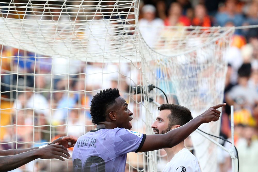 Real Madrid's Vinicius Junior (C) reacts as he points to someone in the crowd during a soccer match in Valencia, Spain.