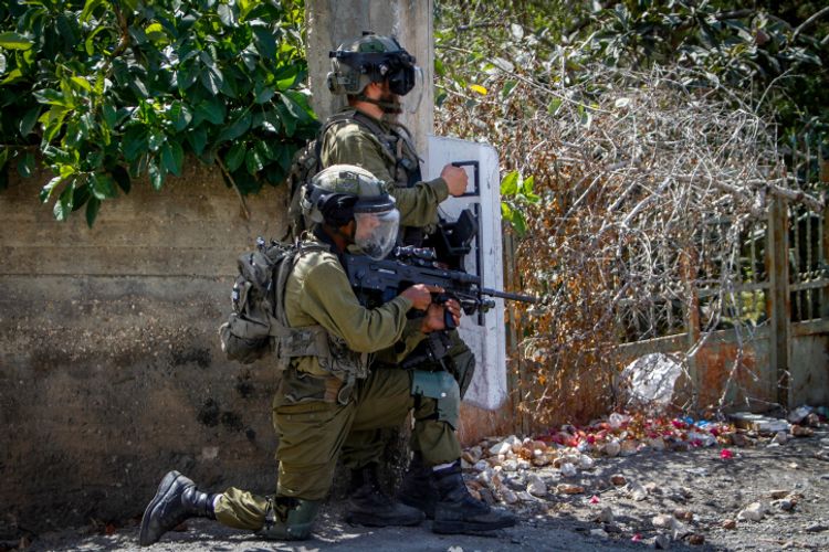 Palestinian demonstrators clash with Israeli security forces during a protest near the West Bank city of Nablus, September 23, 2022.