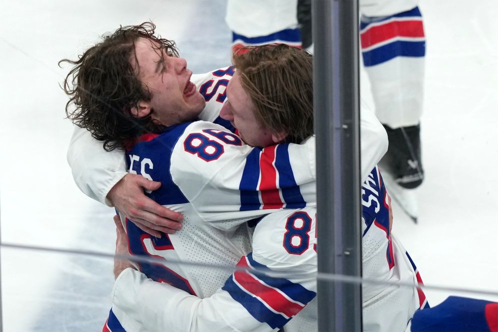 United States' Jack Hughes (86) and Jake Sanderson (85) celebrate after Hughes scored the winning goal in overtime against Canada to win the men's ice hockey gold medal game at the 2026 Winter Olympics in Milan, Italy, Sunday, Feb. 22, 2026
