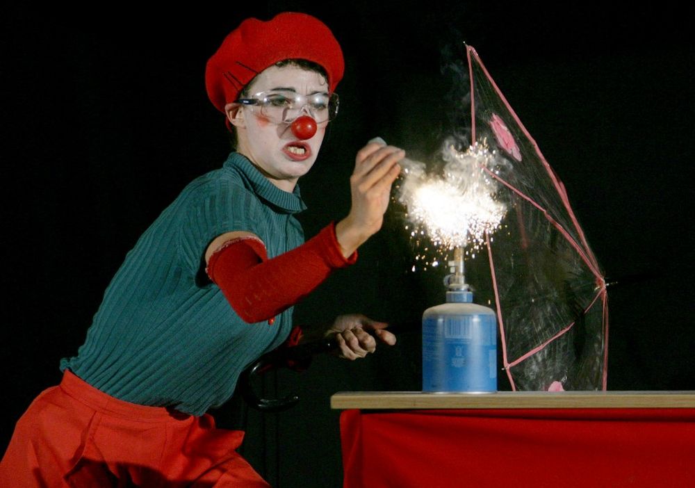 An actress carries out an experiment on stage during a science festival in Paris, France.