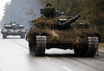 Ukrainian tanks move on a road before an attack in Lugansk region on February 26, 2022.
