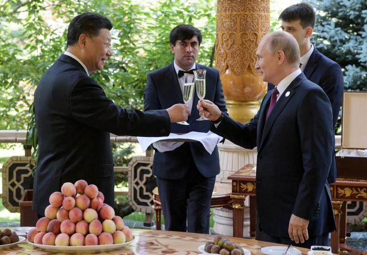 Russia's President Vladimir Putin (R) and China's President Xi Jinping toast at the Diaoyutai State Guesthouse in Dushanbe, China, on June 15, 2019.