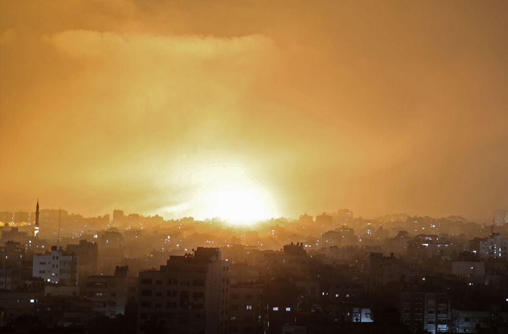 An explosion lights the sky following an Israeli air strike on Beit Lahia in the northern Gaza Strip on May 14, 2021.