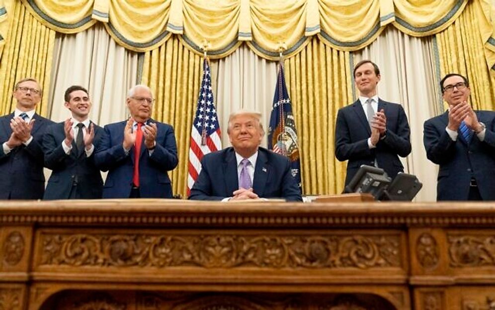 President Donald Trump, center, accompanied by (from left), US special envoy for Iran Brian Hook, Assistant to the President and Special Representative for International Negotiations Avraham Berkowitz, US Ambassador to Israel David Friedman, White House Senior Adviser Jared Kushner, and Treasury Secretary Steven Mnuchin, at the Oval Office in the White House, August 12, 2020, in Washington.
