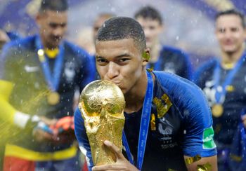 France's Kylian Mbappe kisses the trophy after the final match between France and Croatia at the 2018 soccer World Cup in the Luzhniki Stadium in Moscow, Russia, Sunday, July 15, 2018. France won the final 4-2.