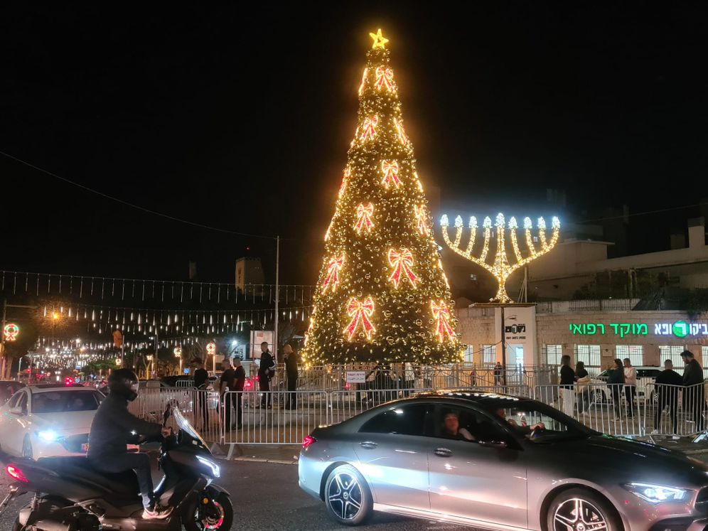 A Christmas tree next to a Hanukkah candlestick in Haifa, Israel, during the Hag HaHagim festival.