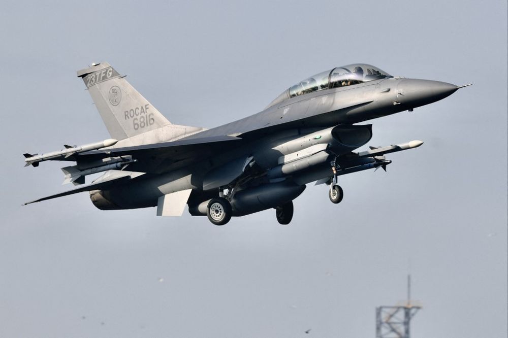 An armed US-made F16 fighter jet takes off from a motorway in Pingtung, southern Taiwan, during the annual Han Kuang drill on September 15, 2021.