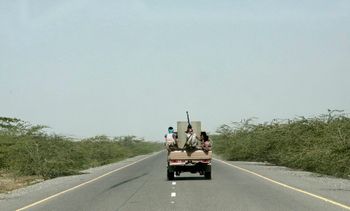 Saudi-backed forces ride in their vehicle in Hodeida, Yemen.