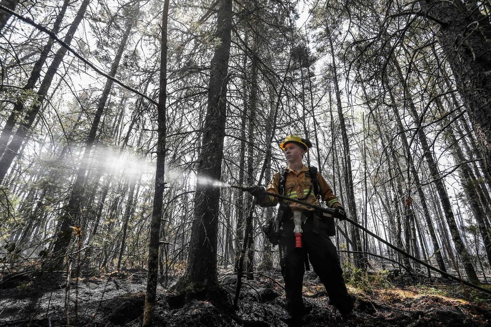 Department of Natural Resources and Renewables firefighter Kalen MacMullin of Sydney, Nova Scotia, works on a fire in Shelburne County.