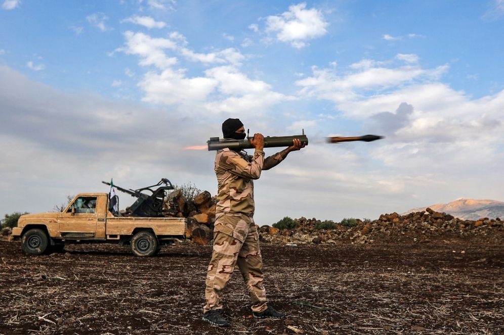 A Syrian fighter fires a rocket-propellered grenade during military drills by the Turkish-backed "Suleiman Shah Division" in the opposition-held Afrin region of northern Syria on November 22, 2022.