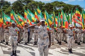 Members of the Ethiopian National Defense Force hold national flags during a ceremony to remember those soldiers who died on the first day of the Tigray conflict, outside the city administration office in Addis Ababa, Ethiopia, on November 3, 2022.