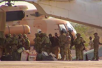 FILE - This undated photograph handed out by French military shows Russian mercenaries boarding a helicopter in northern Mali