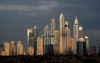 The sunrise reflects on city skylines at the Marina and Jumeirah Lake Towers districts in Dubai, United Arab Emirates, February 27, 2021.