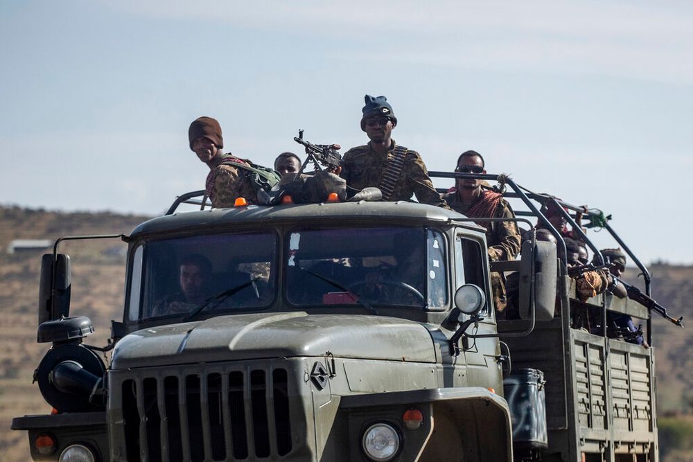 Ethiopian government soldiers ride in the back of a truck on a road near Agula, north of Mekele, in the Tigray region of northern Ethiopia on May 8, 2021.