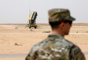 A member of the U.S. Air Force stands near a Patriot missile battery at the Prince Sultan air base in al-Kharj, central Saudi Arabia, February 20, 2020.