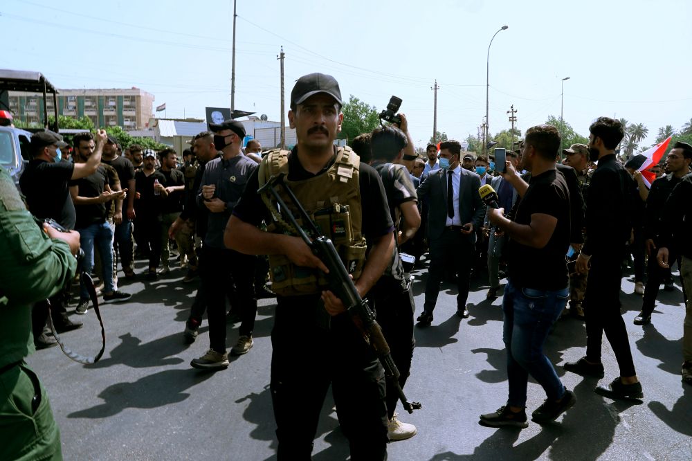 Iran-backed militia fighters march in central Baghdad, Iraq