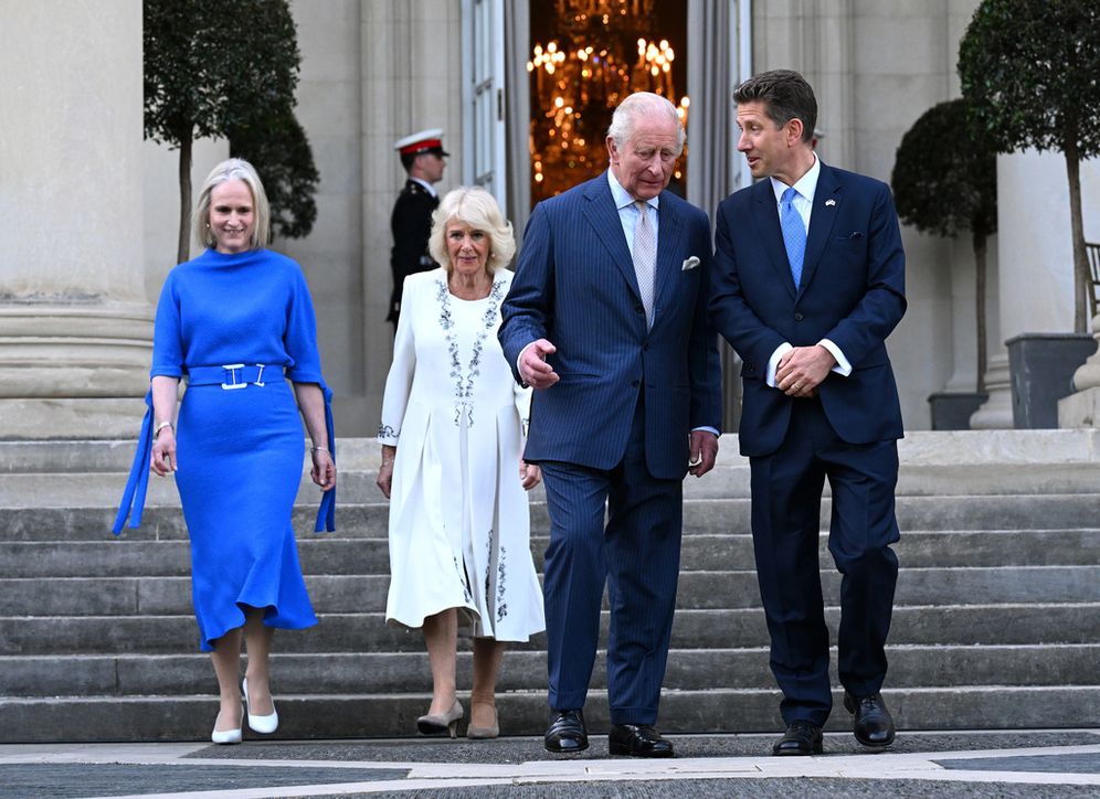 Britain's King Charles III and Queen Camilla arrive at a garden party at the British Embassy with Britain's Ambassador to the U.S, Christian Turner and his wife Claire Turner, left, Monday, April 27, 2026, in Washington