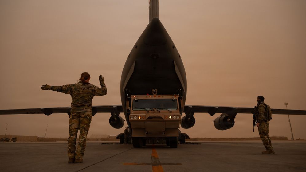 American soldiers unload equipment from a transport plane as part of the transfer of assets to the Middle East amid tensions with Iran.