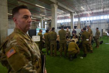 US Army personnel and other officials monitor screens displaying imagery of the Gaza Strip during a media tour of a newly established joint command center operated by the U.S. military's Central Command (CENTCOM) inside the Civil-Military Coordination Center (CMCC), archive