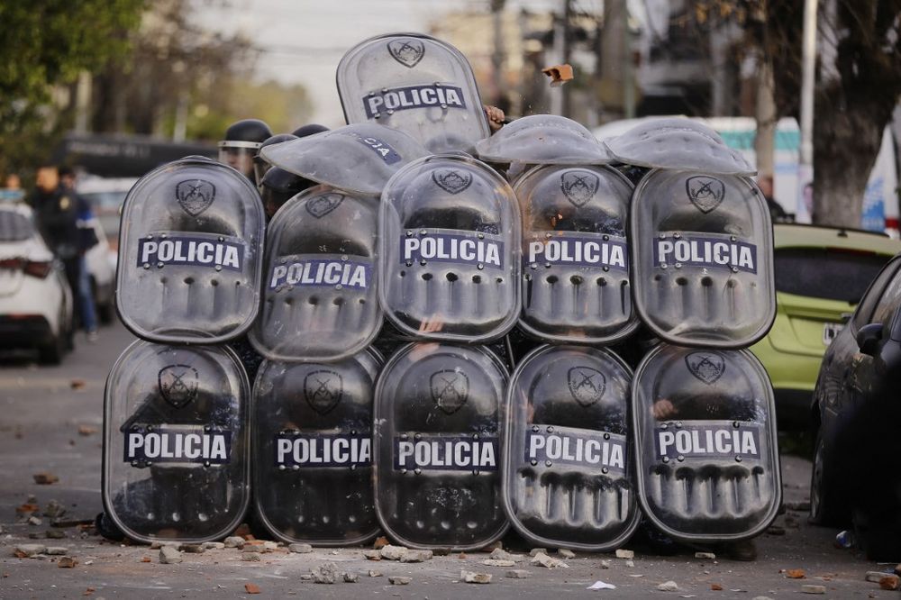 Police barricade during clashes at a demonstration to denounce the death of a little girl in a pickpocketing incident in Buenos Aires, Argentina,