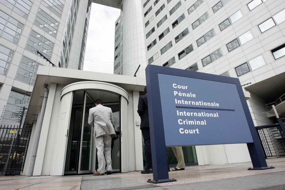 People enter the International Criminal Court in the Hague, the Netherlands, on June 20, 2006.