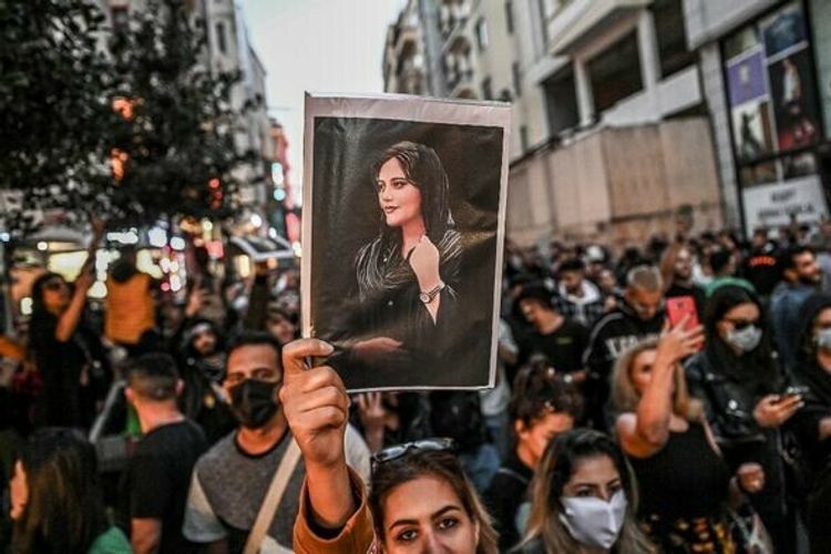 A protester holds a portrait of Mahsa Amini during a demonstration on Istiklal avenue in Istanbul, Turkey, on September 20, 2022.