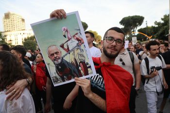 Protesters, with a poster depicting Prime Minister Edi Rama, take part in a rally in Tirana, Saturday, June 6, 2026, against the construction of a massive coastal development project linked to Jared Kushner and Ivanka Trump at Narta lagoon area, western Albania
