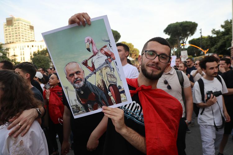 Protesters, with a poster depicting Prime Minister Edi Rama, take part in a rally in Tirana, Saturday, June 6, 2026, against the construction of a massive coastal development project linked to Jared Kushner and Ivanka Trump at Narta lagoon area, western Albania
