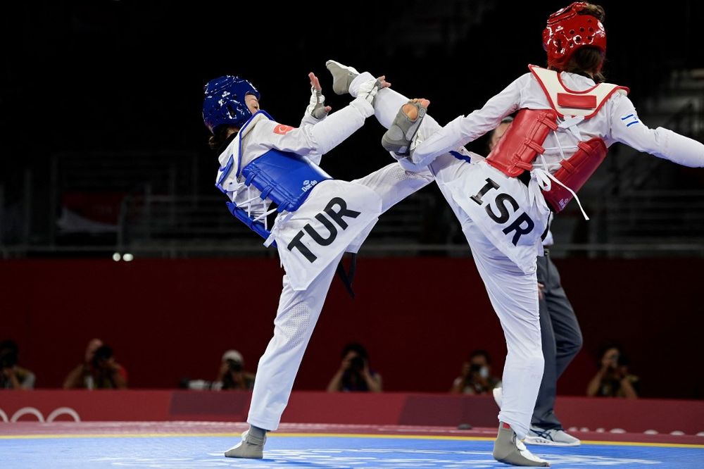 Taekwondo fighters from Turkey (L) and Israel compete during the Tokyo 2020 Olympic Games in Tokyo, Japan, on July 24, 2021.