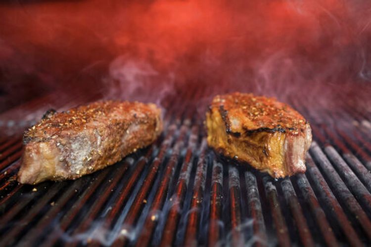 Steaks on a grill at a restaurant in New York, the United States, November 17, 2018.