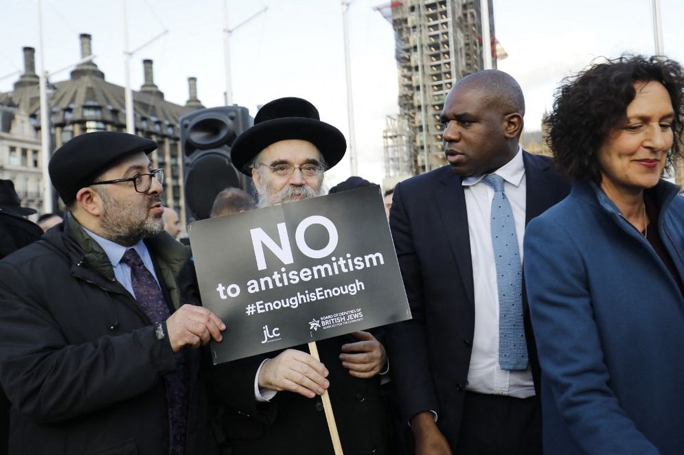 British Labour Party politician, David Lammy (R) joins members of the Jewish community holding a protest against antisemitism in the Labour party in London, UK, on March 26, 2018.