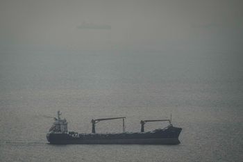 A cargo ship carrying vehicles sails through the Arabian Gulf toward the Strait of Hormuz in the United Arab Emirates, Sunday, March 22, 2026
