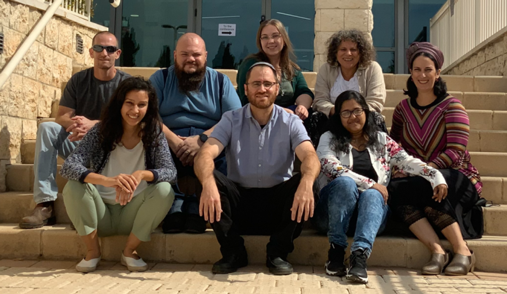 Professor Evan Elliott (center) with members of his lab at Azrieli Faculty of Medicine, of Bar-Ilan University, Israel.