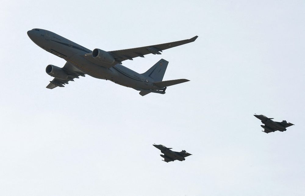French air force Airbus A330 Multi Role Tanker Transport plane (L), and its two rafale fighter escorts, fly over the Istres military base.