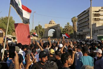 Supporters of Iraqi Shiite cleric Muqtada al-Sadr gather outside the main gate of Baghdad's Green Zone on July 27, 2022.