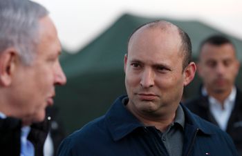 Israeli Prime Minister Benjamin Netanyahu, left, and then-Defense Minister Naftali Bennett, visit an Israeli army base in the Golan Heights, on the Israeli-Syrian border, November 24, 2019.