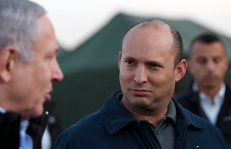 Israeli Prime Minister Benjamin Netanyahu, left, and then-Defense Minister Naftali Bennett, visit an Israeli army base in the Golan Heights, on the Israeli-Syrian border, November 24, 2019.