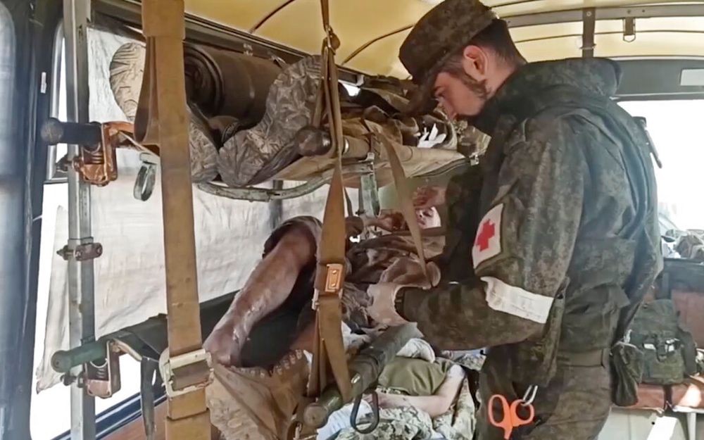 Wounded Ukrainian servicemen receive treatment in a bus as they are evacuated from the besieged Azovstal steel plant in Mariupol, Ukraine, May 17.