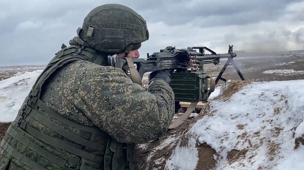 This handout video grab taken and released by the Russian Defence Ministry on February 2, 2022 shows a soldier firing a machinegun on a firing range in Belarus.