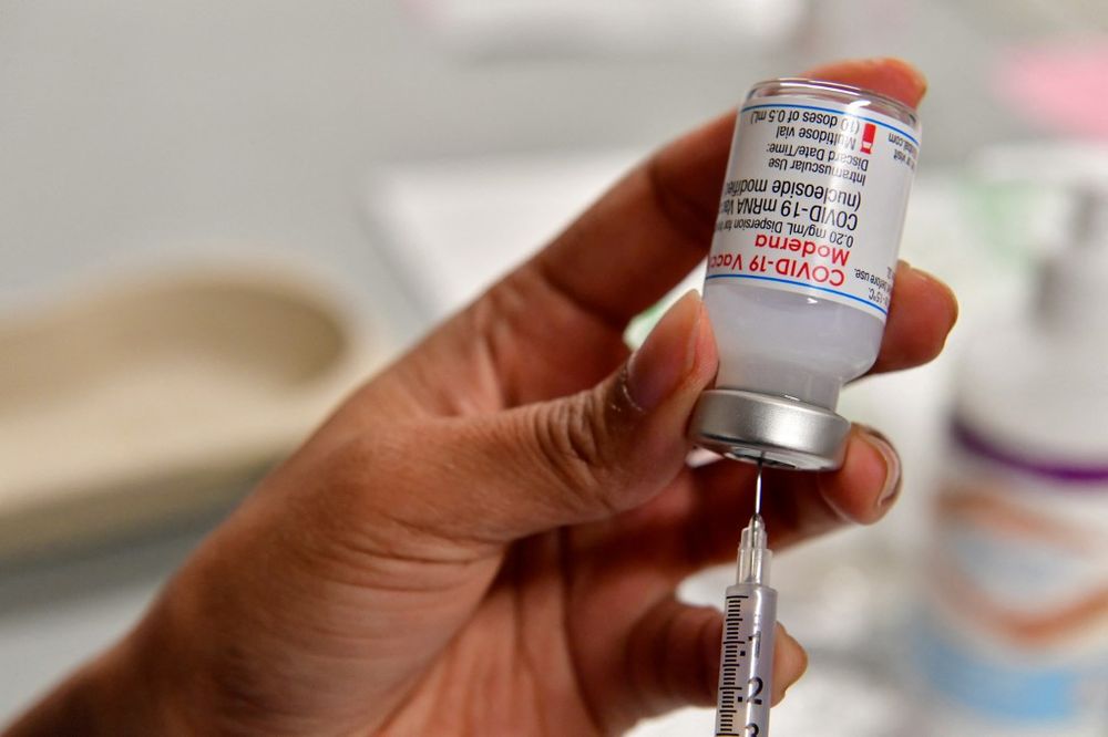 Health worker prepares a dose of Moderna Covid-19 booster vaccine at the Toulouse's exhibition centre used as a vaccination centre in Toulouse, France, on December 9, 2021.