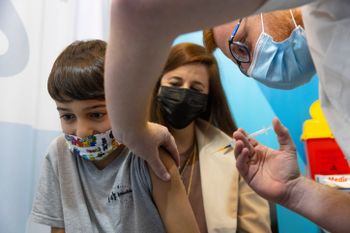 An Israeli child receives a dose of the Covid-19 vaccine in Jerusalem on November 28, 2021.