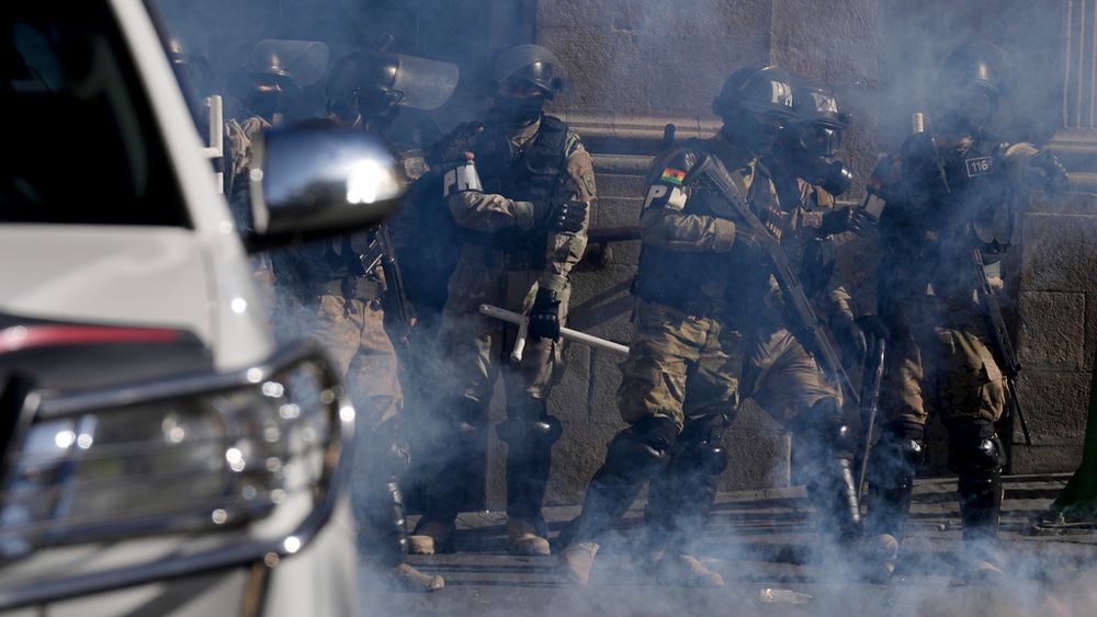 Military Police stand amid tear gas they fired outside the presidential palace in Plaza Murillo in La Paz, Bolivia, Wednesday, June 26, 2024.