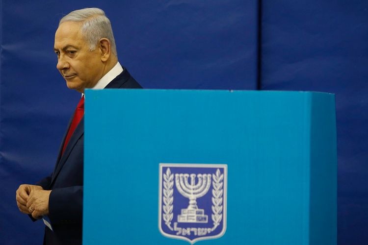 Israel's Prime Minister Benjamin Netanyahu votes during Israel's parliamentary elections in Jerusalem, Tuesday, April 9, 2019