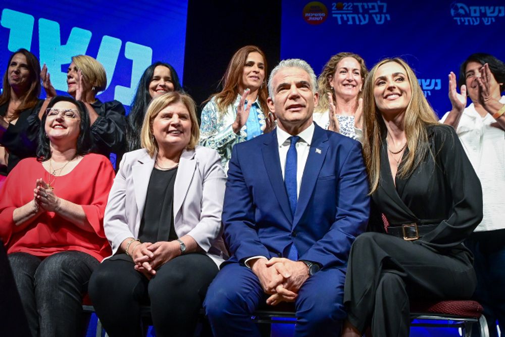 Israel's Prime Minister and leader of the Yesh Atid party Yair Lapid poses for a picture with women from the Yesh Atid party during an election campaign event in Tel Aviv, Israel, on September 8, 2022.
