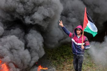 Palestinians burn tires during a protest on the border with Israel, east of Gaza City.