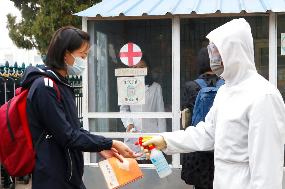 A girl disinfects her hands before entering a school in Pyongyang, North Korea, on November 3, 2021.