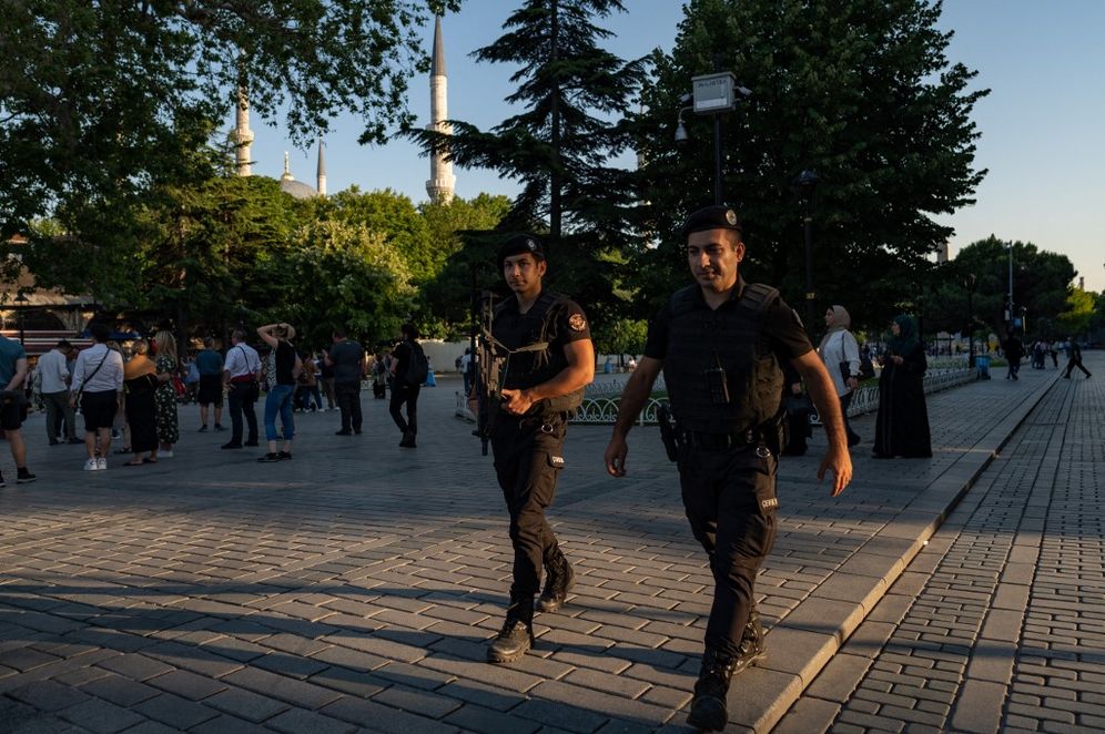Two Turkish riot police officers walk near the Blue Mosque in Istanbul, Turkey, on June 14, 2022.